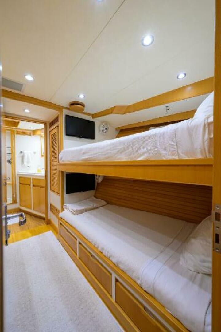 a room with a bed and a television aboard ELECTRA Yacht for Sale