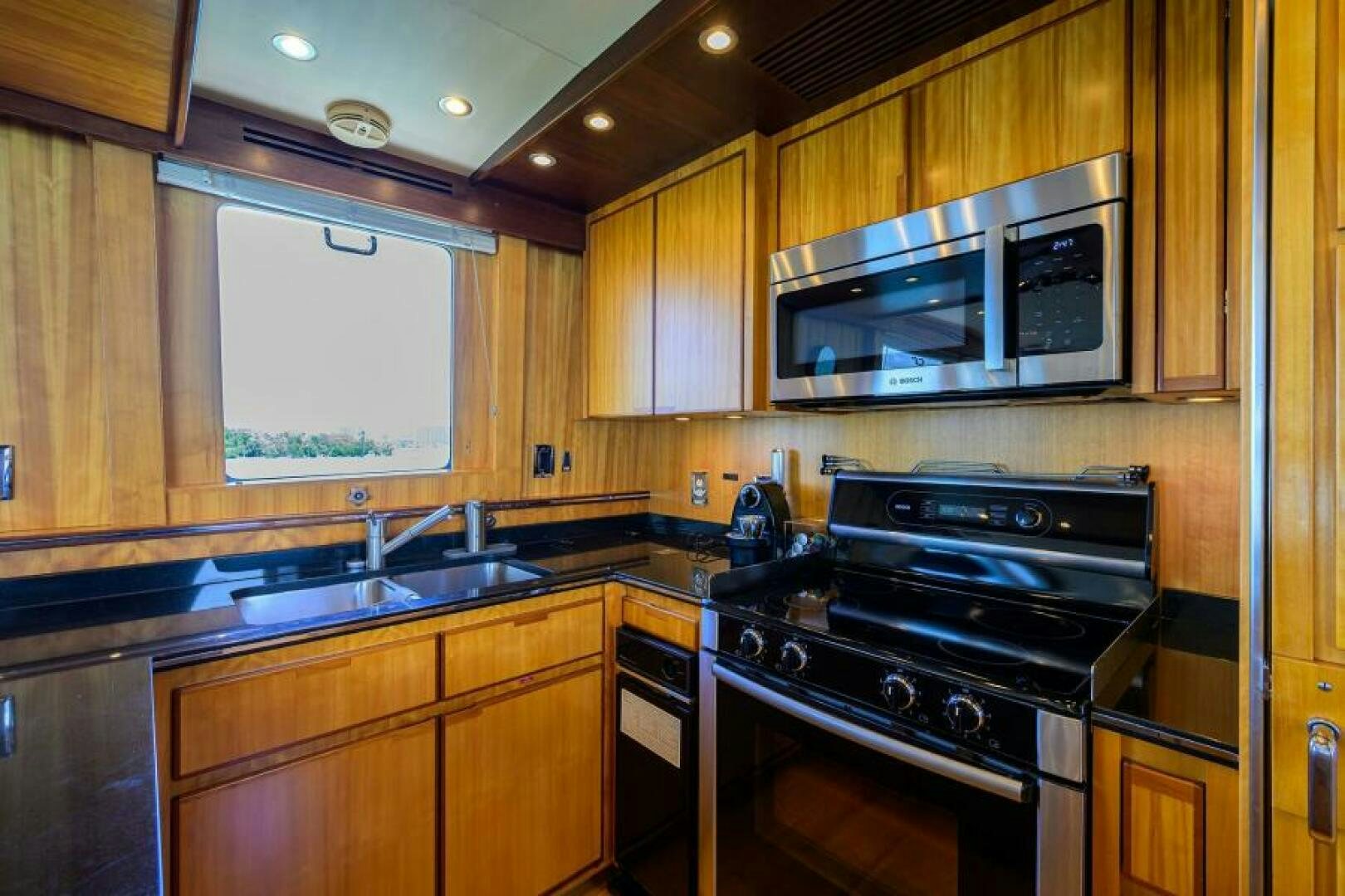 a kitchen with wooden cabinets aboard ELECTRA Yacht for Sale
