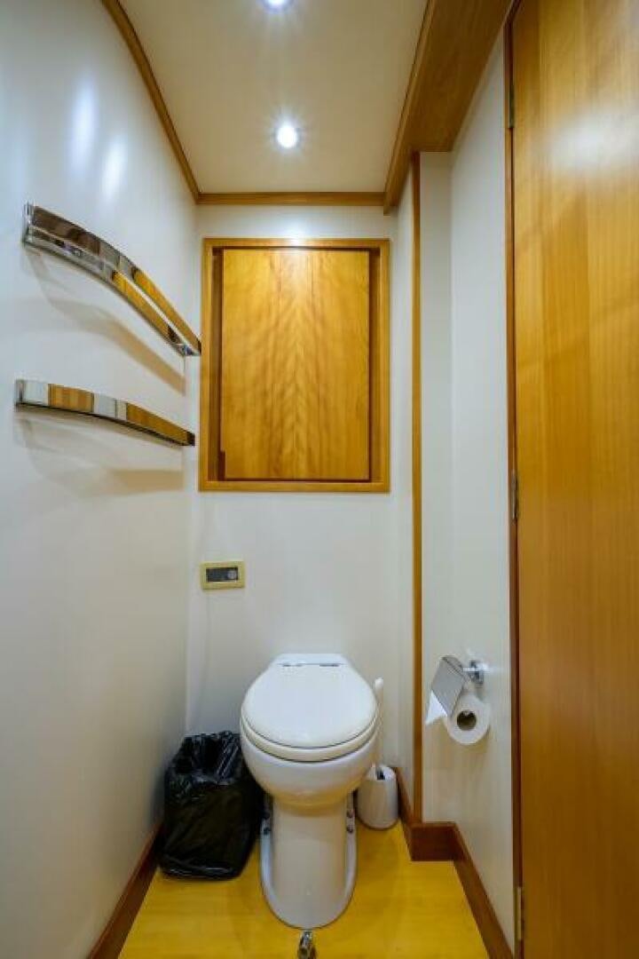 a bathroom with a toilet and a trash can aboard ELECTRA Yacht for Sale