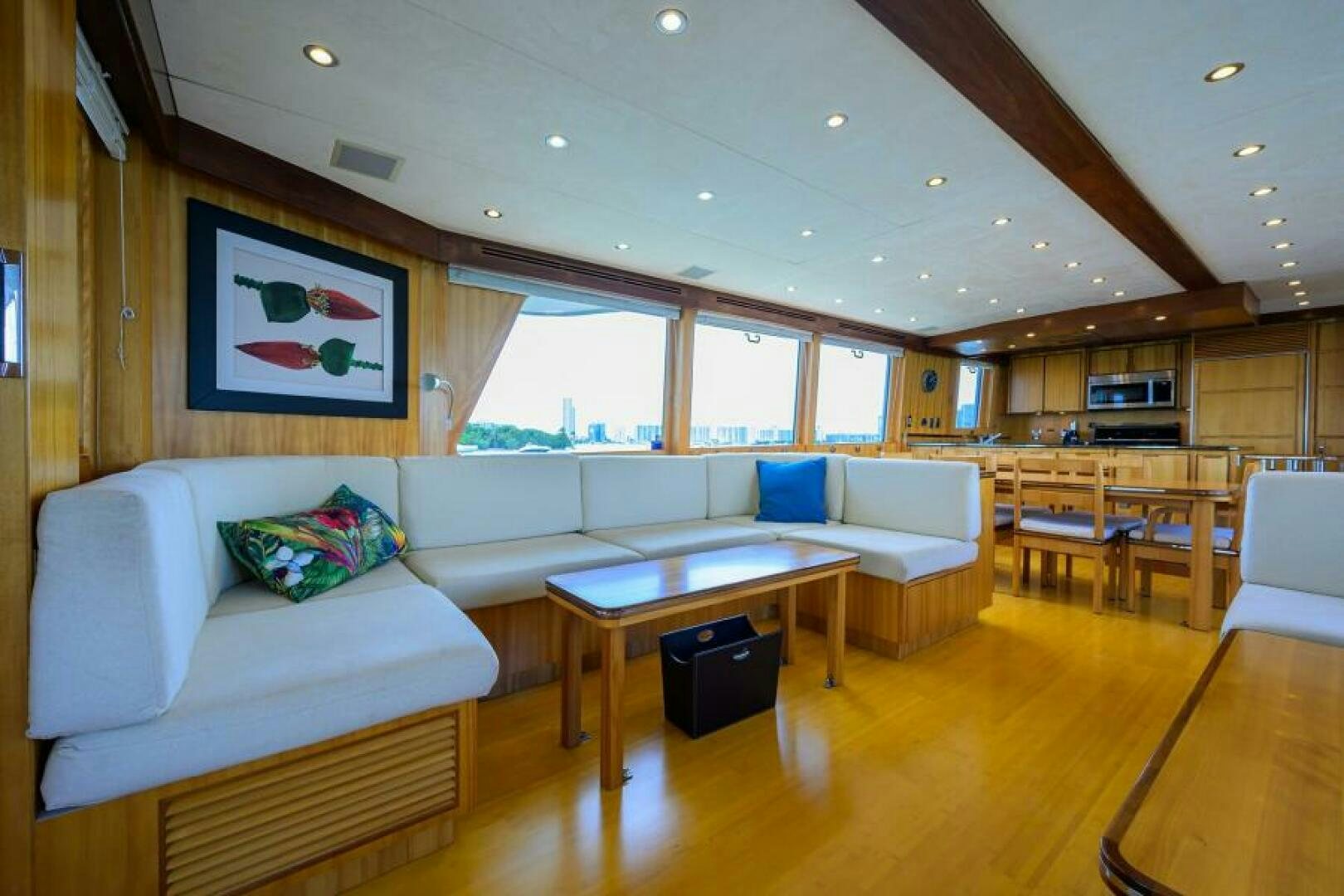 a living room with a table and couches aboard ELECTRA Yacht for Sale