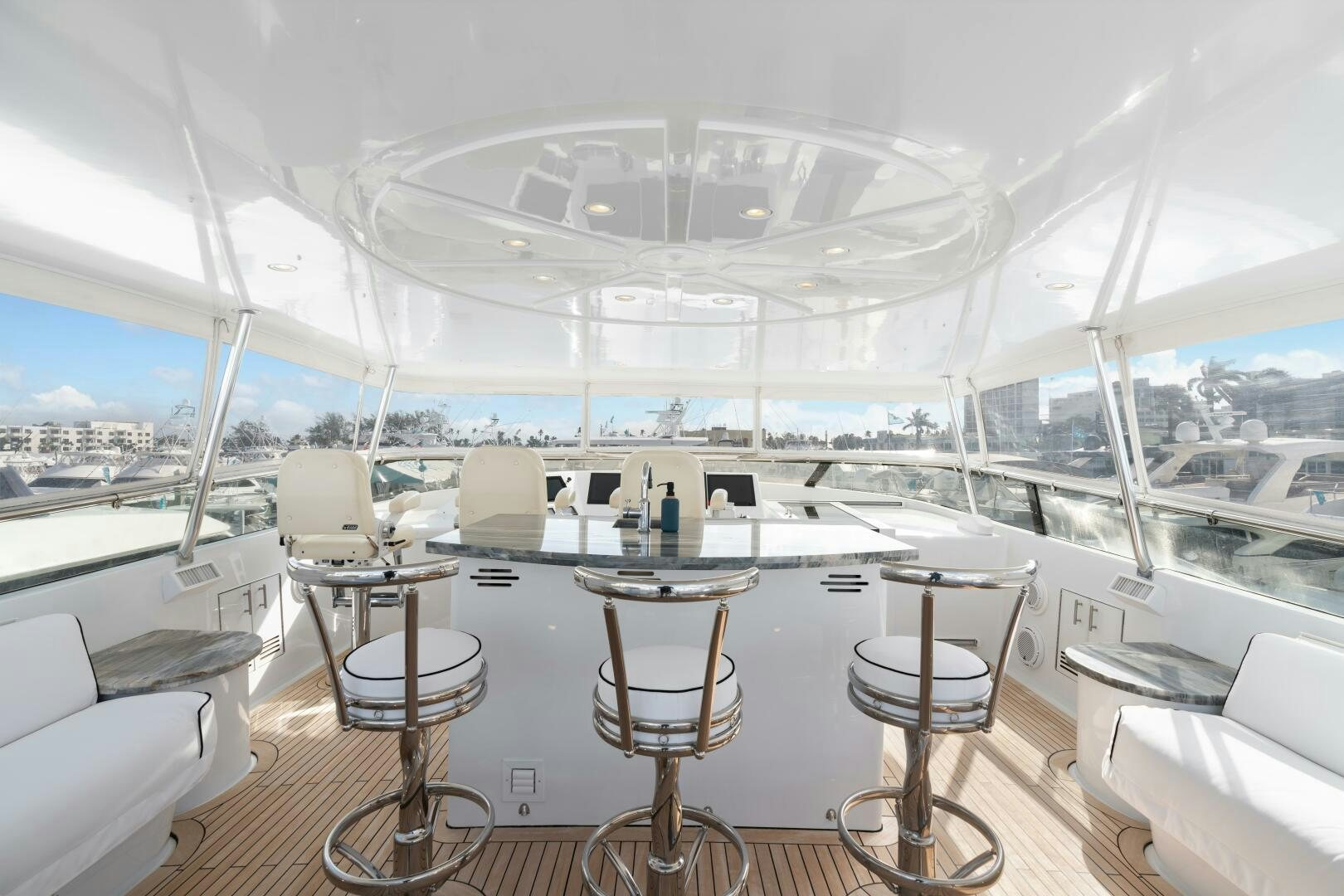 a room with tables and chairs aboard INEVITABLE Yacht for Sale