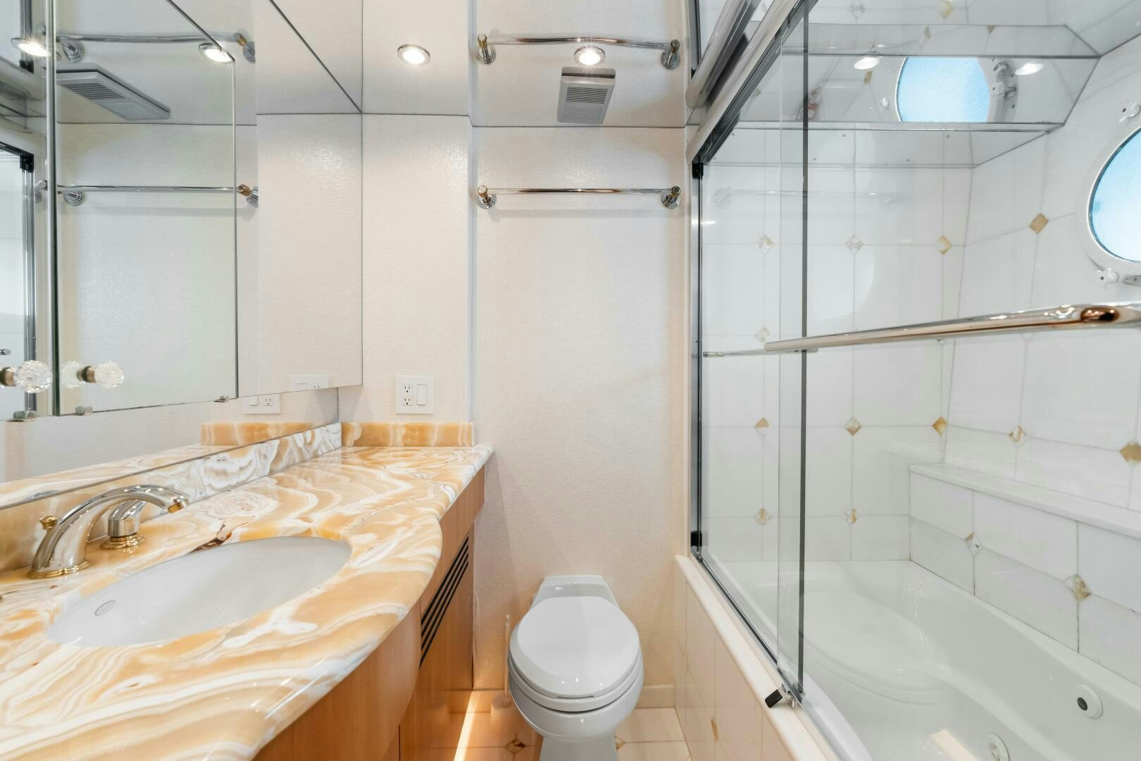 a bathroom with a sink toilet and bathtub aboard INEVITABLE Yacht for Sale