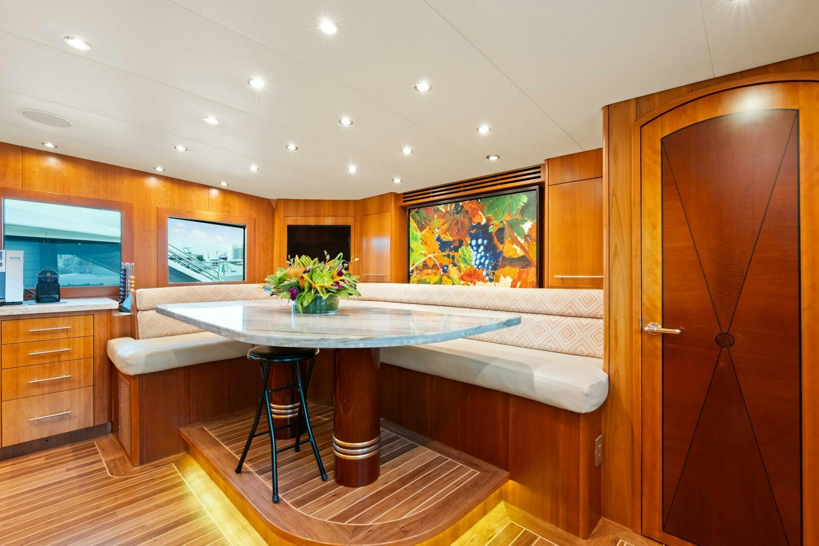 a room with a table and chairs aboard INEVITABLE Yacht for Sale