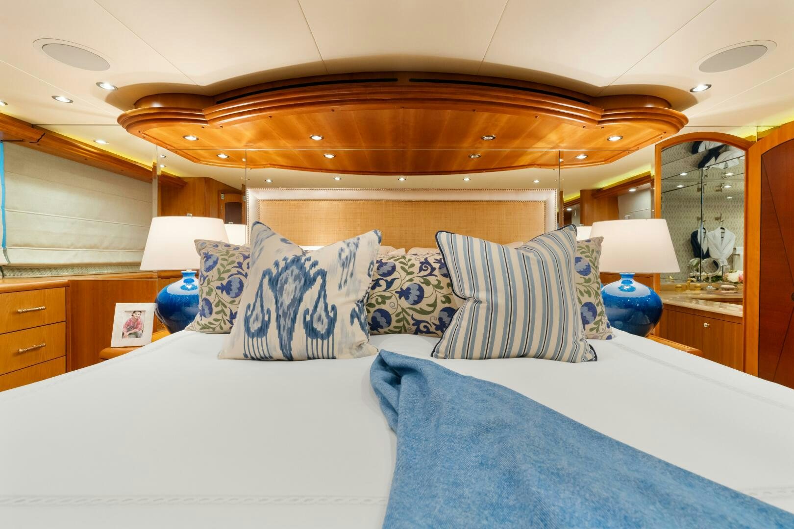 a bed with blue sheets aboard INEVITABLE Yacht for Sale