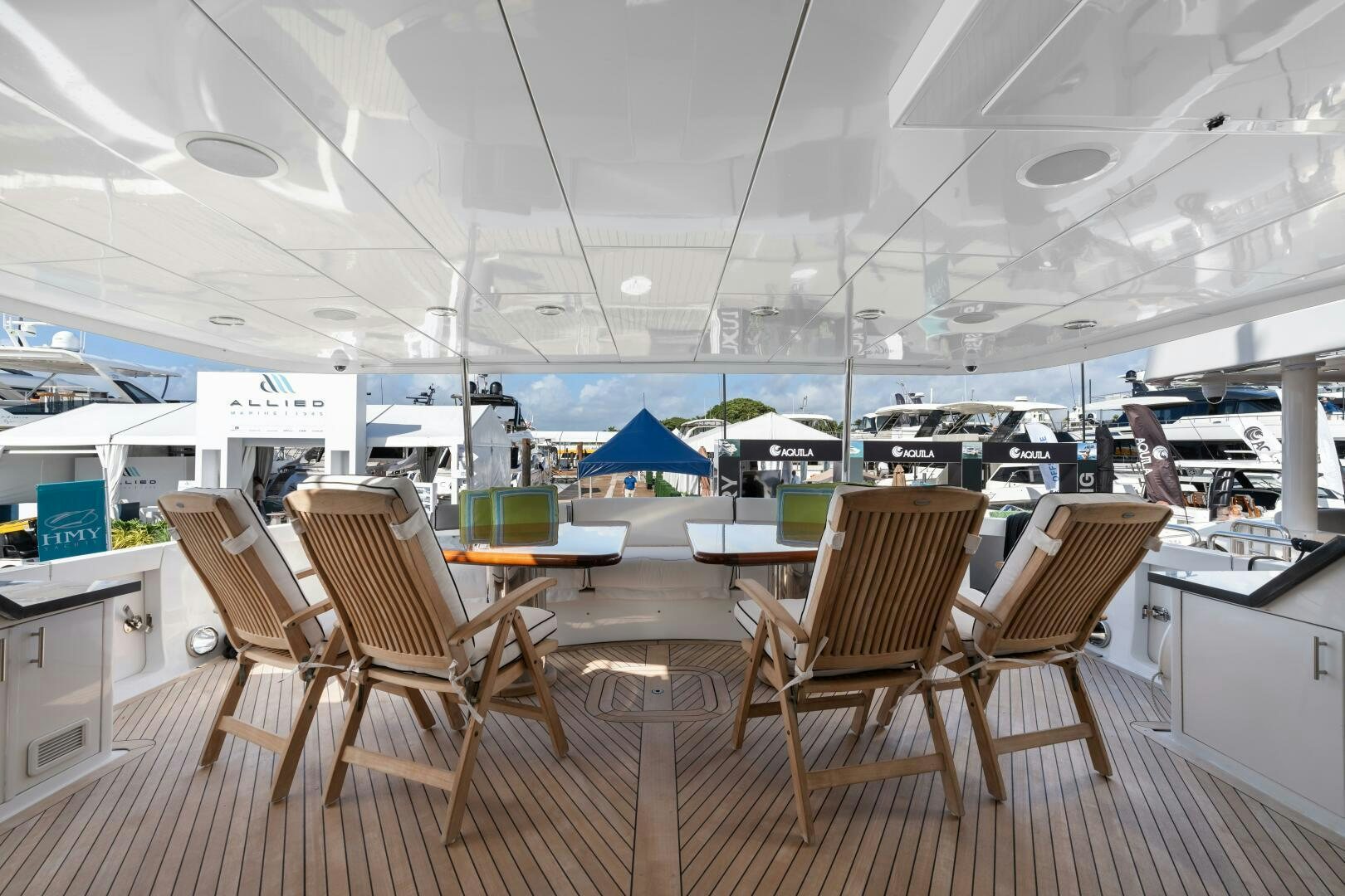 a room with tables and chairs aboard INEVITABLE Yacht for Sale