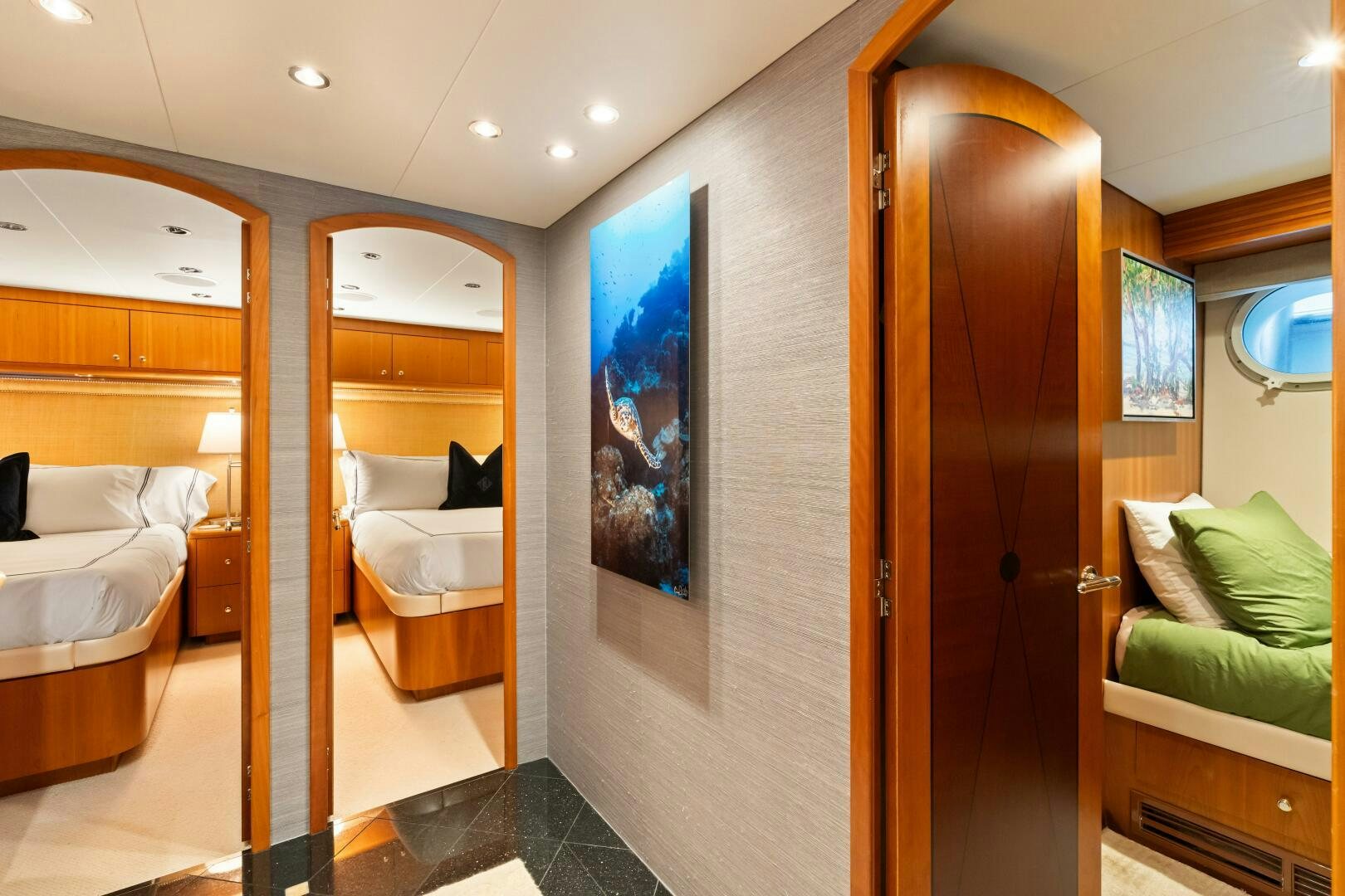 a room with a large mirror and a couch aboard INEVITABLE Yacht for Sale