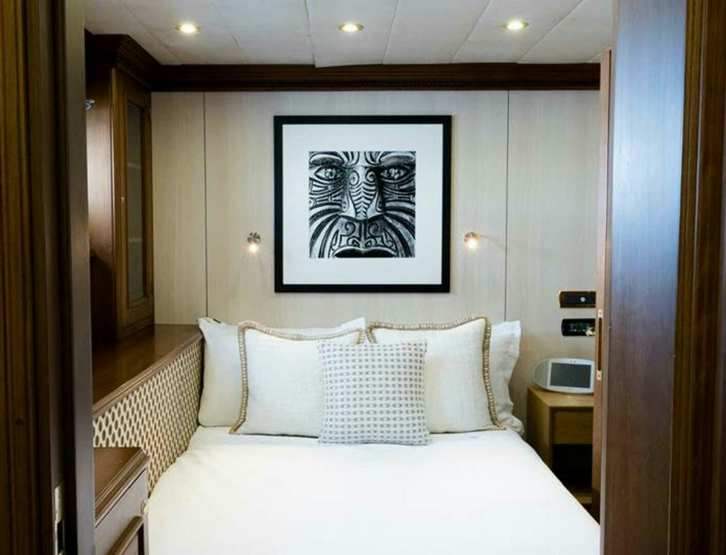 a bed with white sheets and pillows aboard IRAMA Yacht for Sale