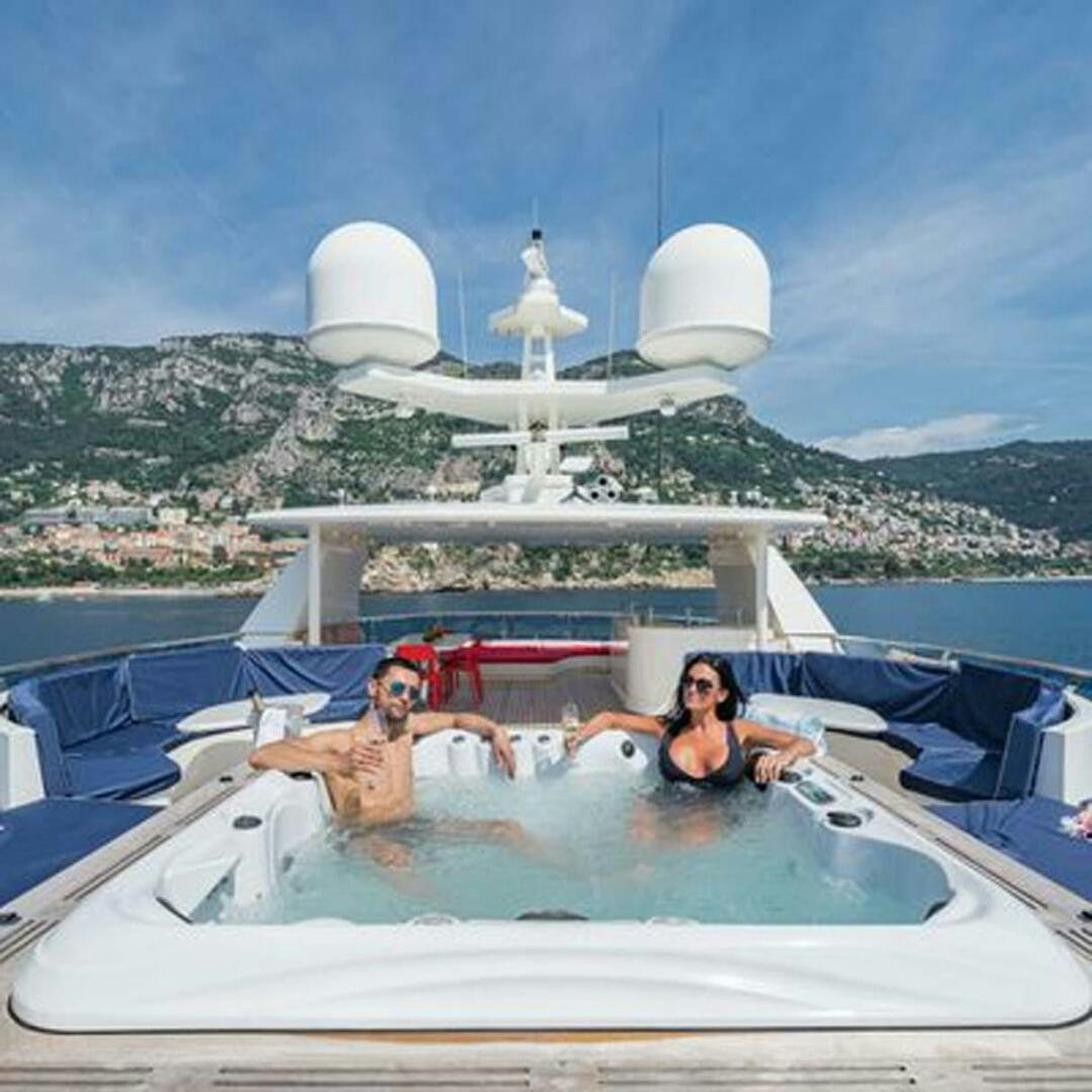a group of people in a hot tub aboard IRAMA Yacht for Sale
