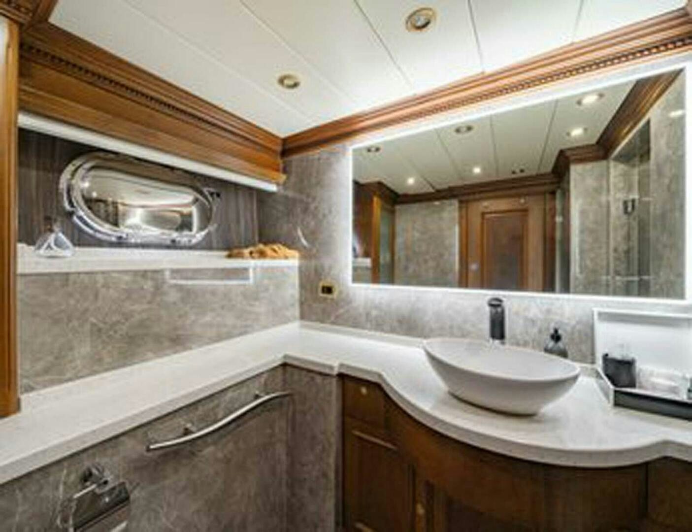 a bathroom with a large mirror aboard IRAMA Yacht for Sale