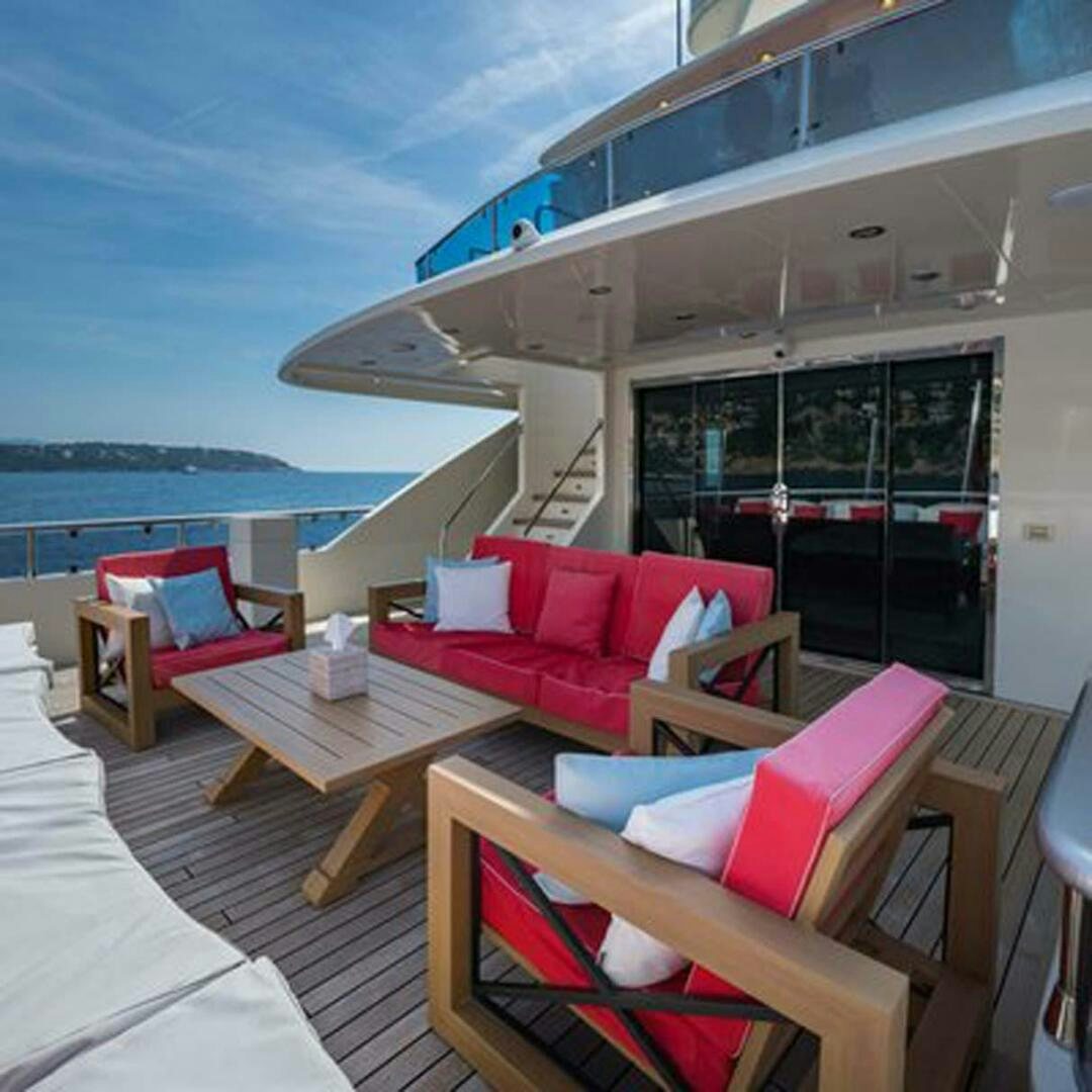 a living room with a large balcony aboard IRAMA Yacht for Sale
