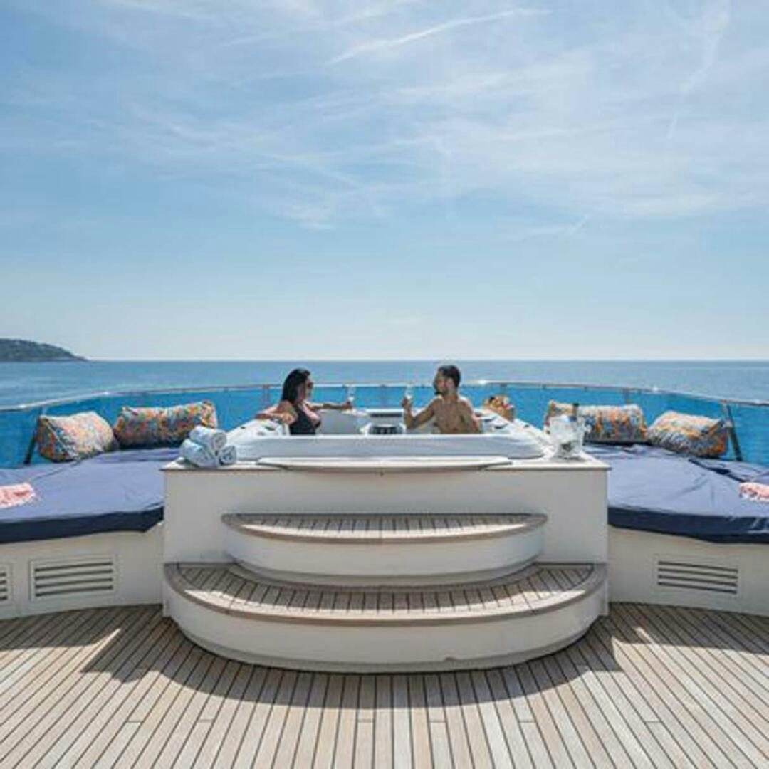 a group of people sitting on a boat aboard IRAMA Yacht for Sale