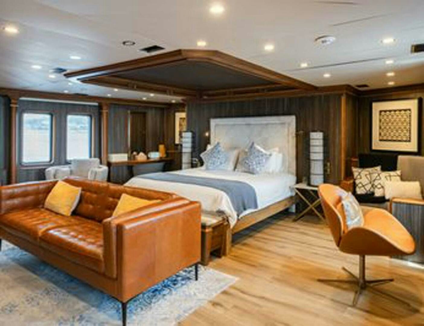 a large bedroom with a large bed aboard IRAMA Yacht for Sale