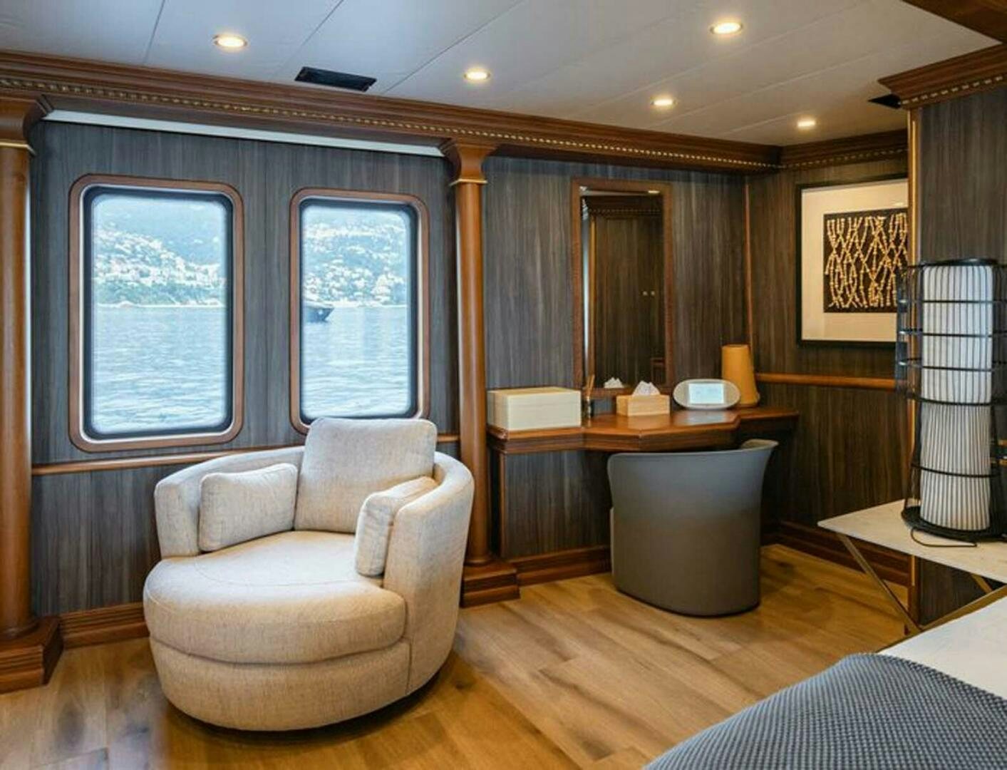 a living room with a large window aboard IRAMA Yacht for Sale