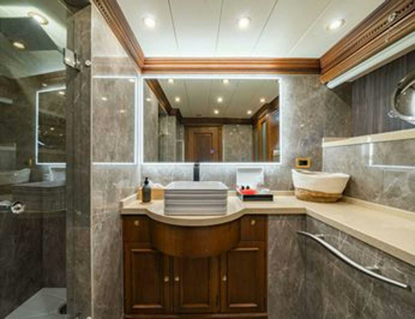 a bathroom with a sink and a mirror aboard IRAMA Yacht for Sale