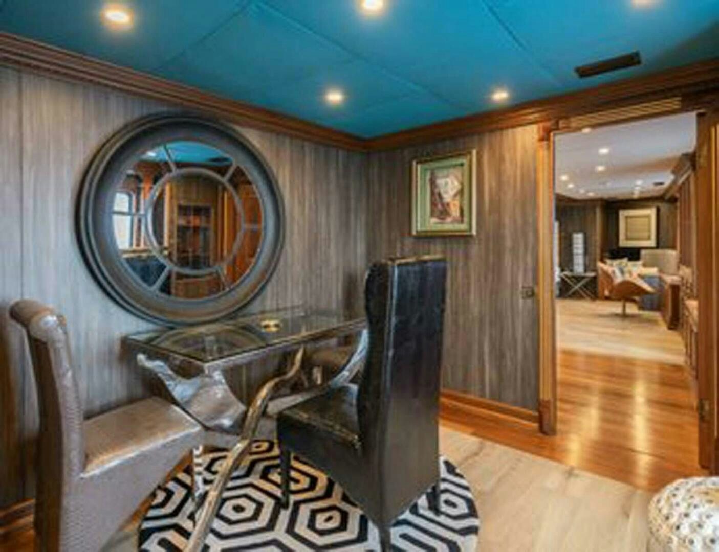 a room with a mirror and a couch aboard IRAMA Yacht for Sale