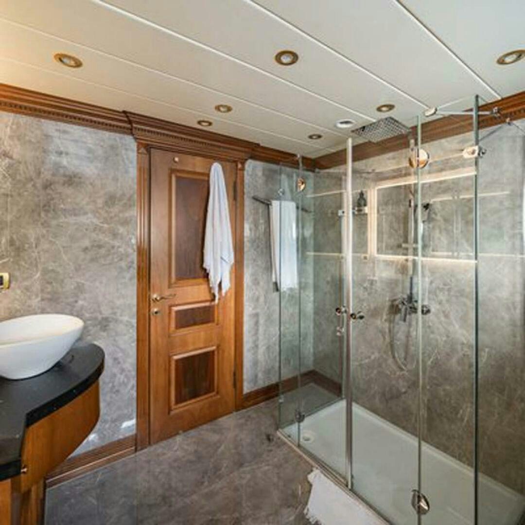 a bathroom with a glass shower aboard IRAMA Yacht for Sale