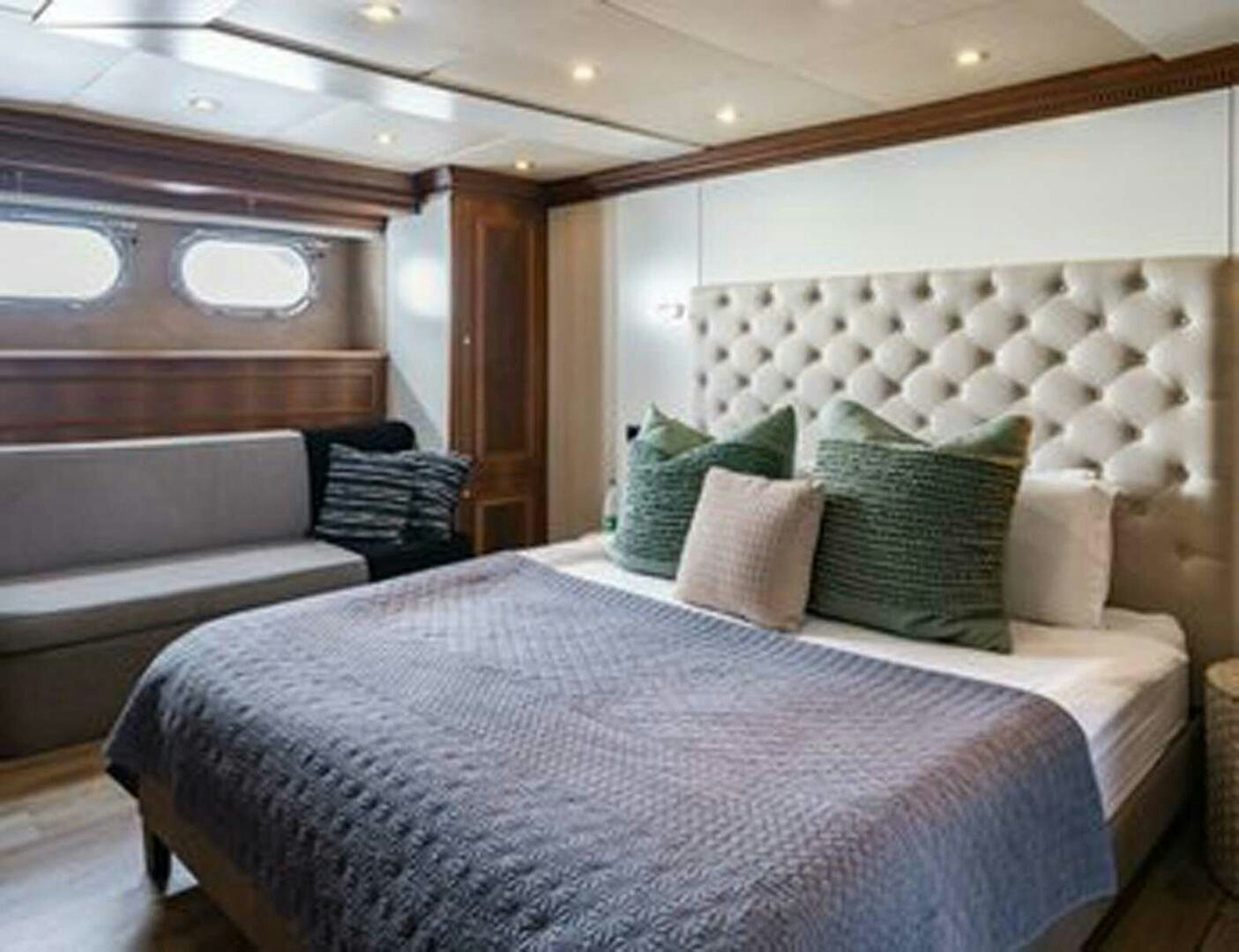 a room with a bed and a couch aboard IRAMA Yacht for Sale