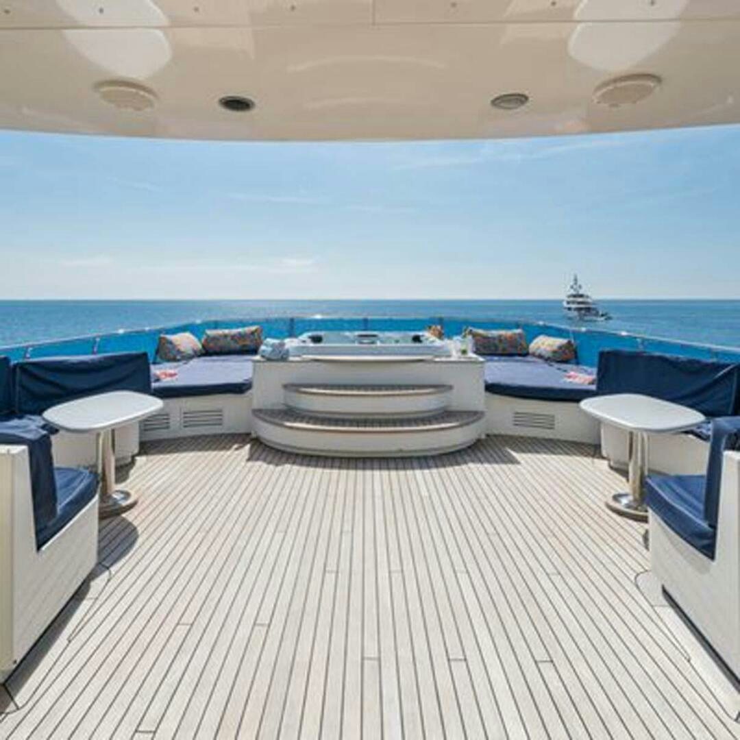 a room with a table and chairs aboard IRAMA Yacht for Sale