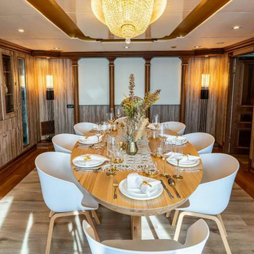 a large dining room table aboard IRAMA Yacht for Sale