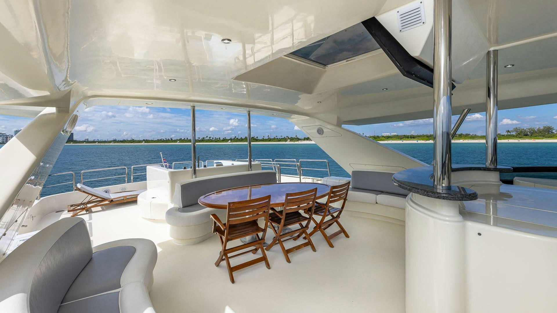a room with a table and chairs aboard 100 AZIMUT JUMBO Yacht for Sale