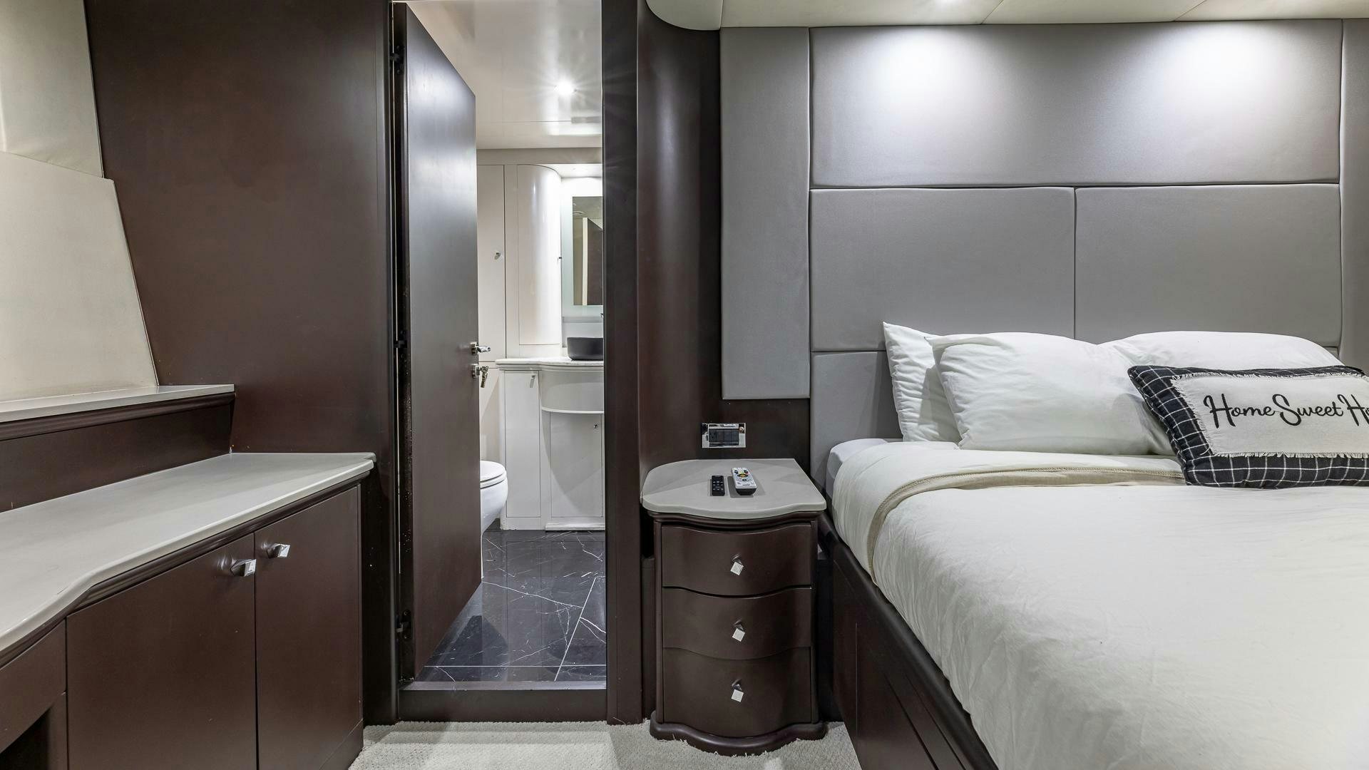 a bedroom with a bed and a mirror aboard 100 AZIMUT JUMBO Yacht for Sale