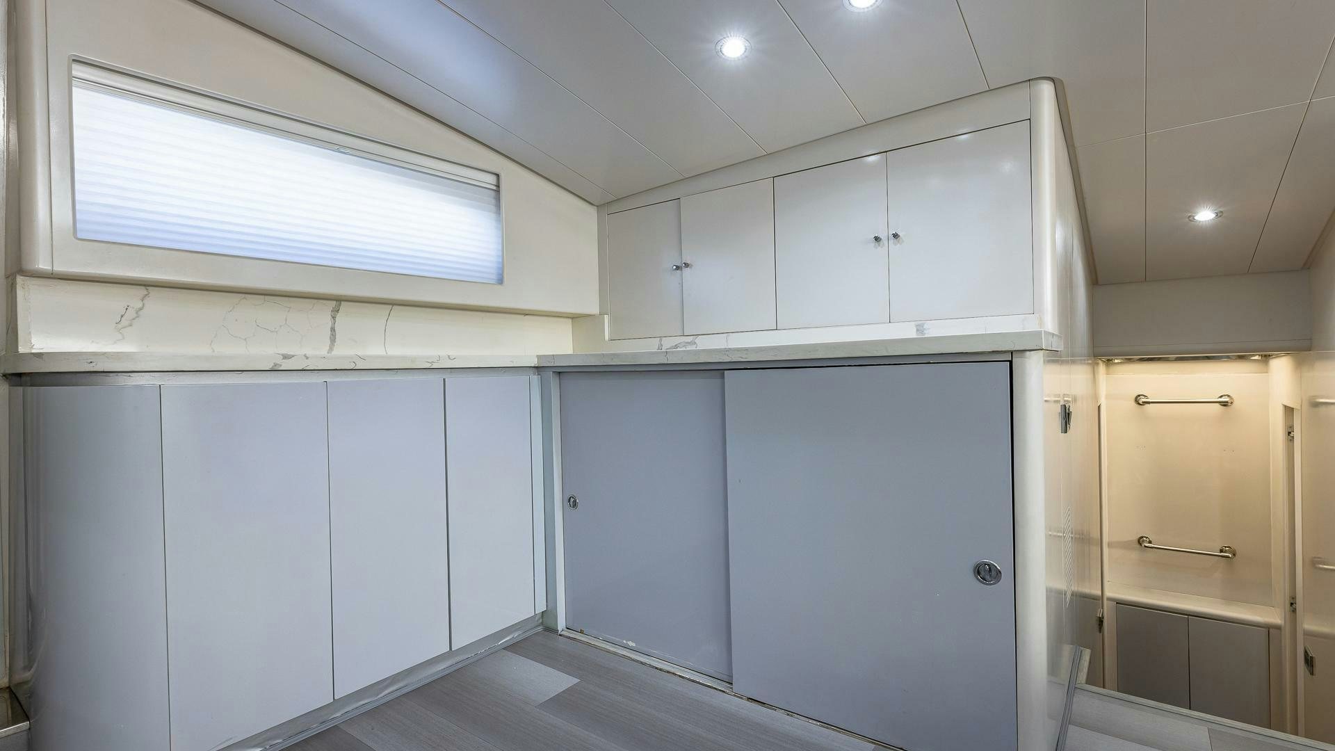 a room with white cabinets aboard 100 AZIMUT JUMBO Yacht for Sale