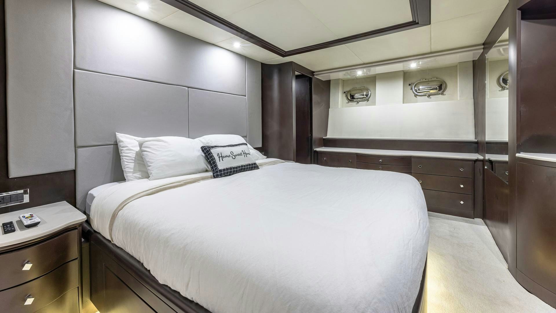 a room with a bed and a desk aboard 100 AZIMUT JUMBO Yacht for Sale