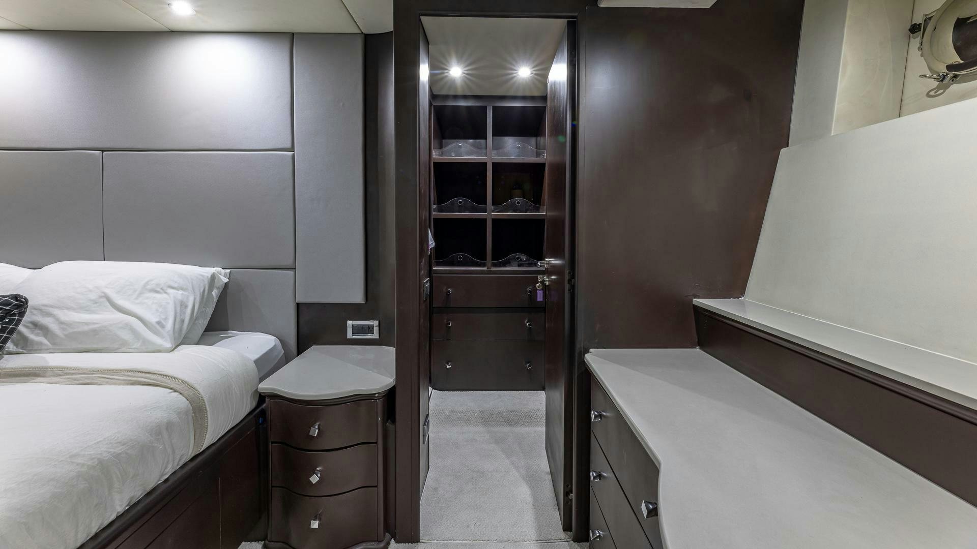a room with a bed and a closet aboard 100 AZIMUT JUMBO Yacht for Sale