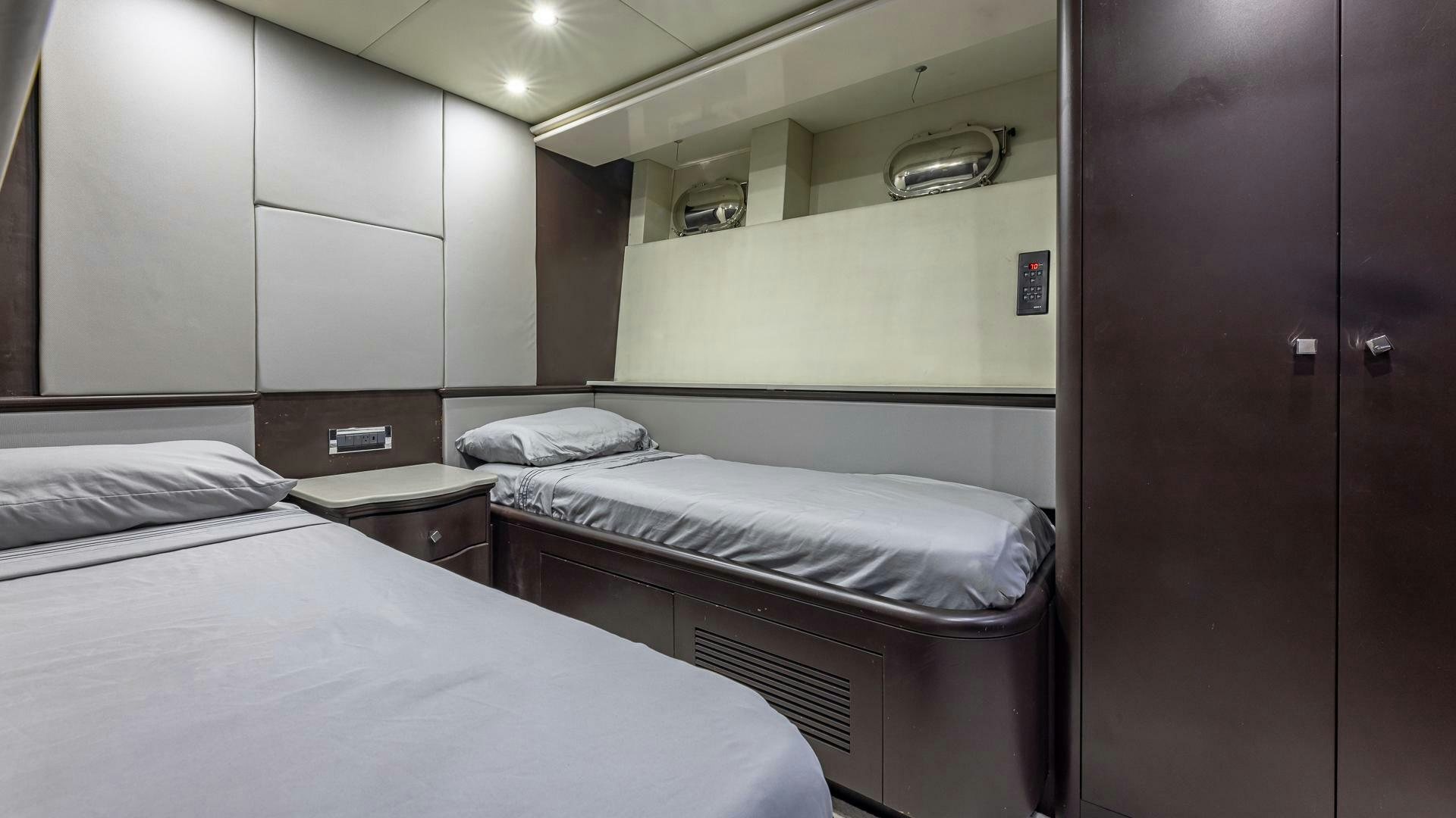 a couple of beds in a room aboard 100 AZIMUT JUMBO Yacht for Sale