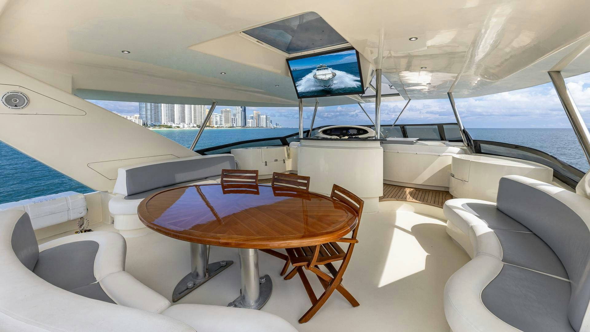 a room with a table and chairs aboard 100 AZIMUT JUMBO Yacht for Sale