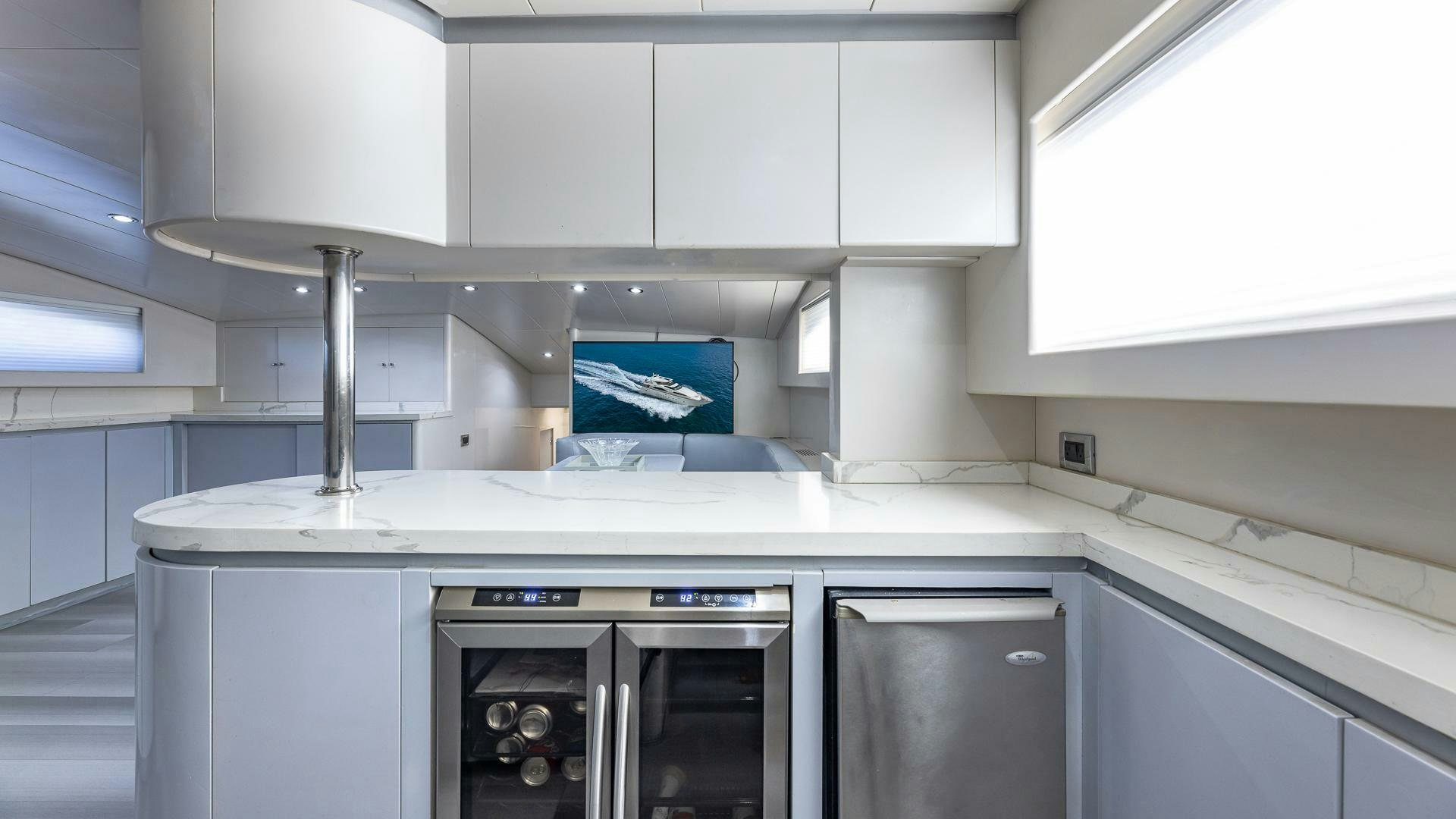 a kitchen with white cabinets aboard 100 AZIMUT JUMBO Yacht for Sale