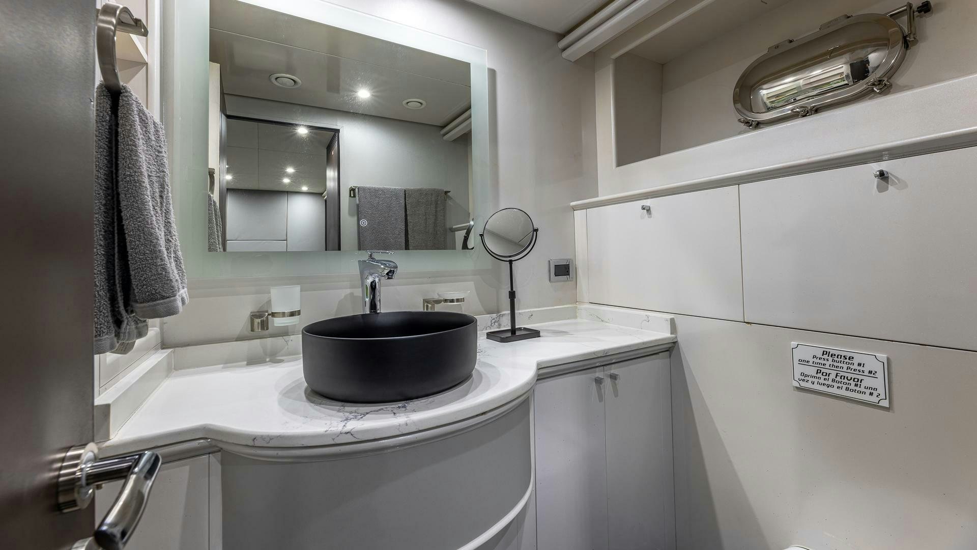 a bathroom with a sink and a mirror aboard 100 AZIMUT JUMBO Yacht for Sale