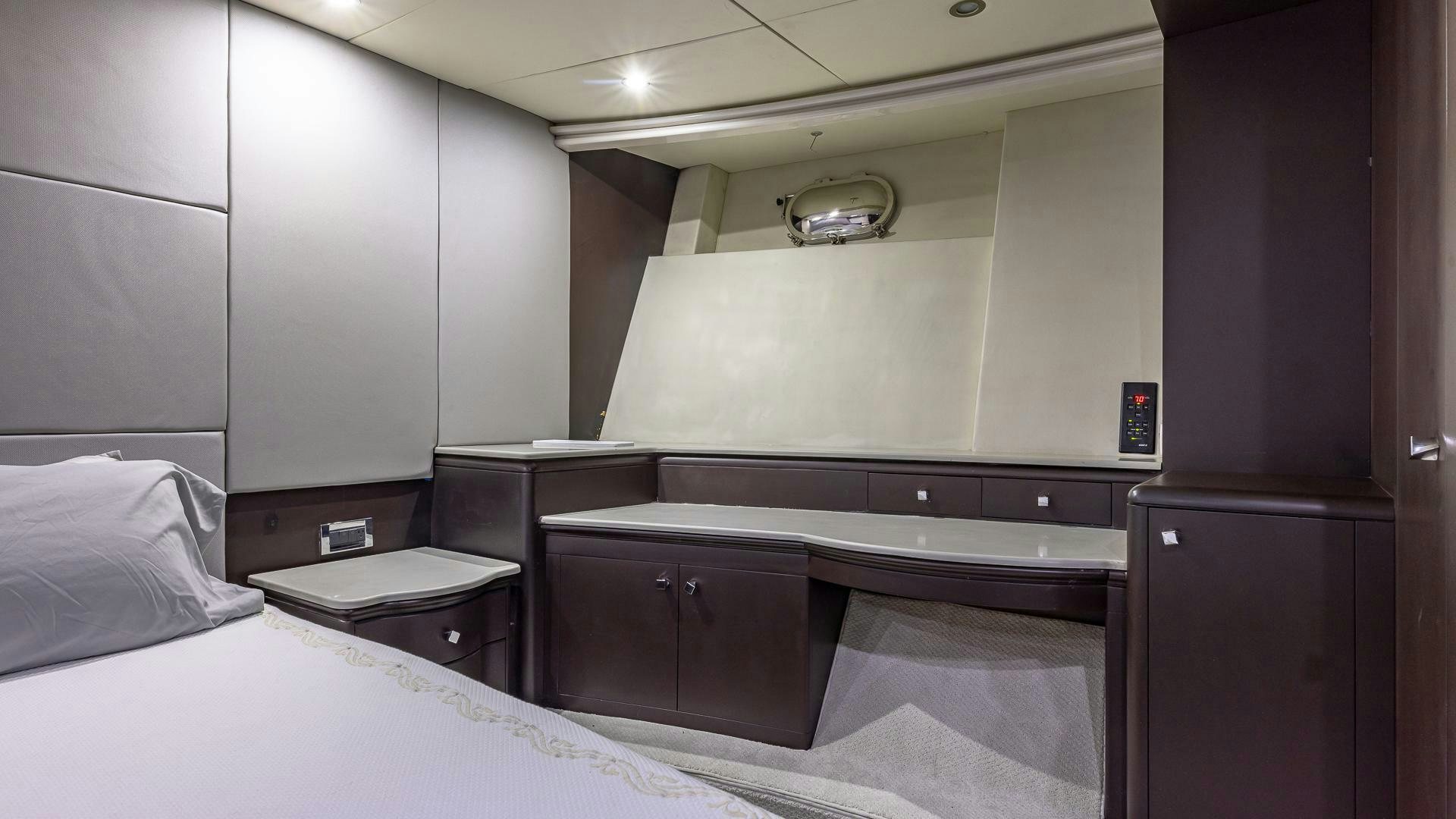 a room with a bed and a desk aboard 100 AZIMUT JUMBO Yacht for Sale