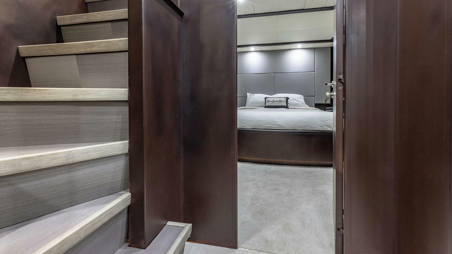 a room with a bed and a wood door aboard 100 AZIMUT JUMBO Yacht for Sale