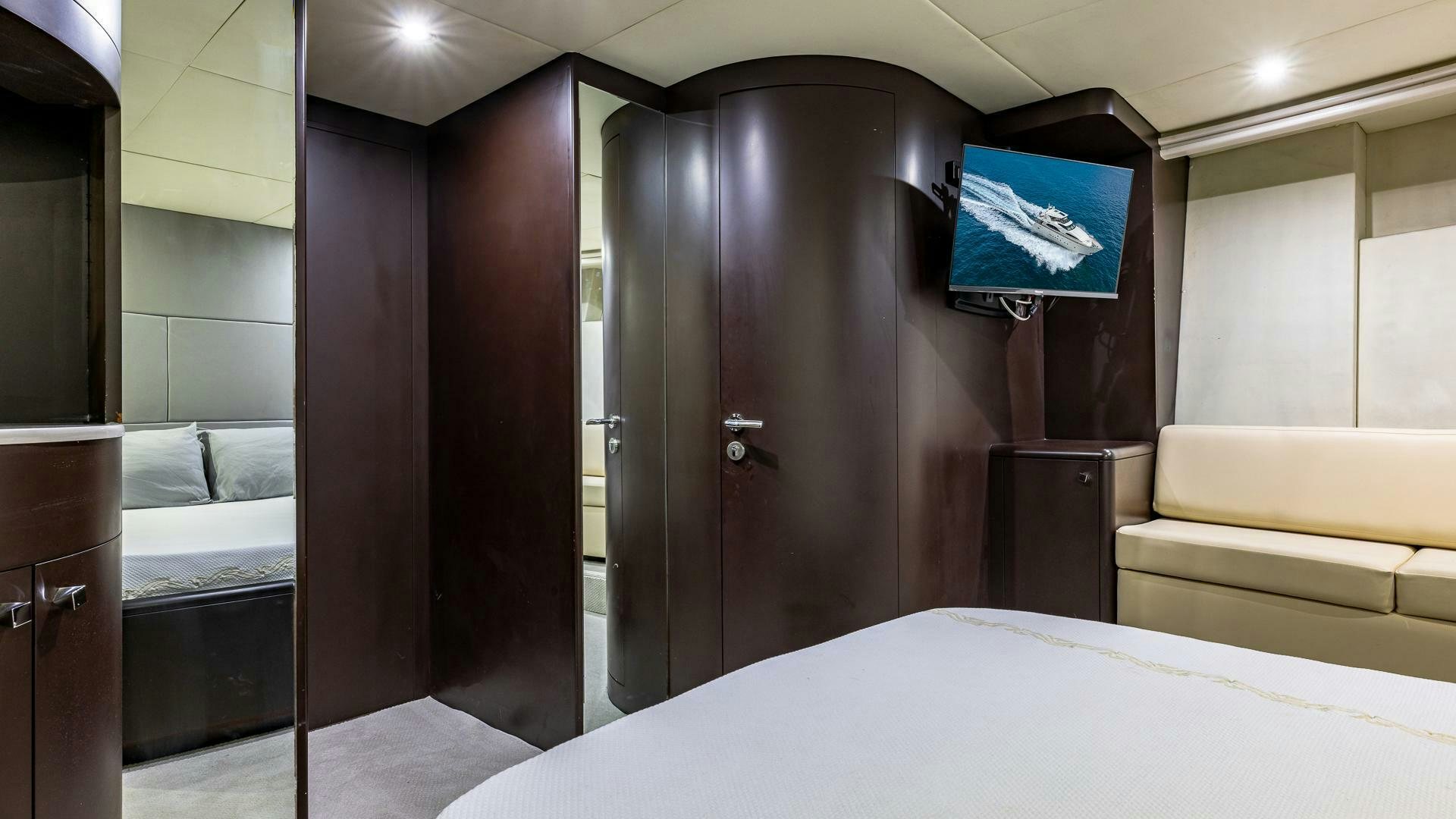 a hotel room with a bed and tv aboard 100 AZIMUT JUMBO Yacht for Sale