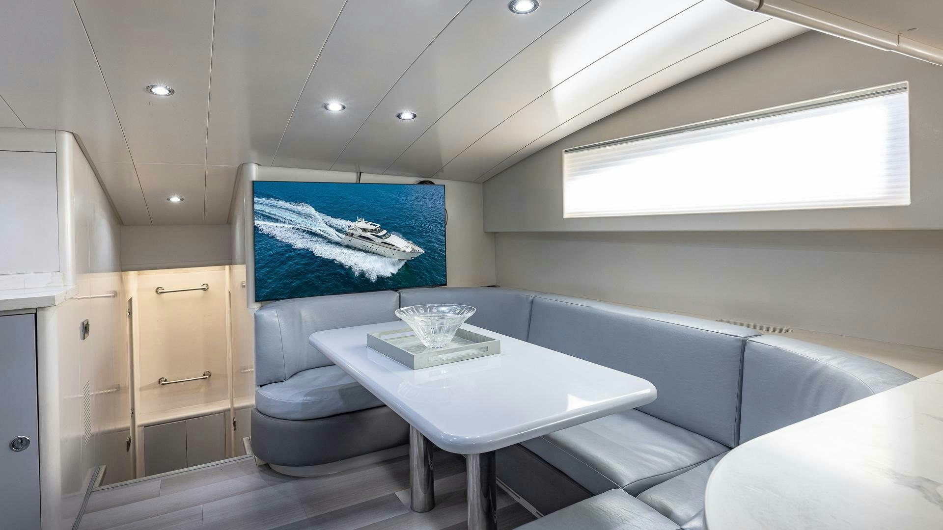 a room with a table and chairs aboard 100 AZIMUT JUMBO Yacht for Sale