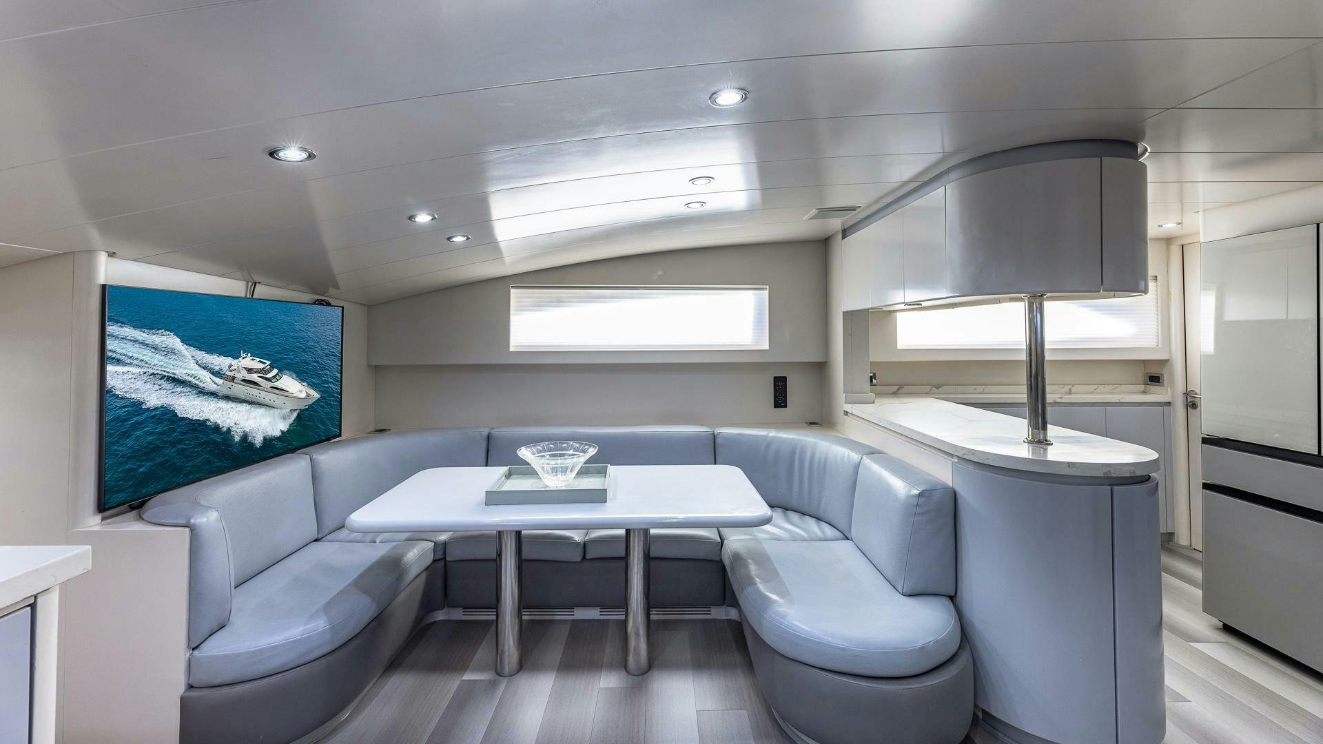 a room with a table and chairs aboard 100 AZIMUT JUMBO Yacht for Sale
