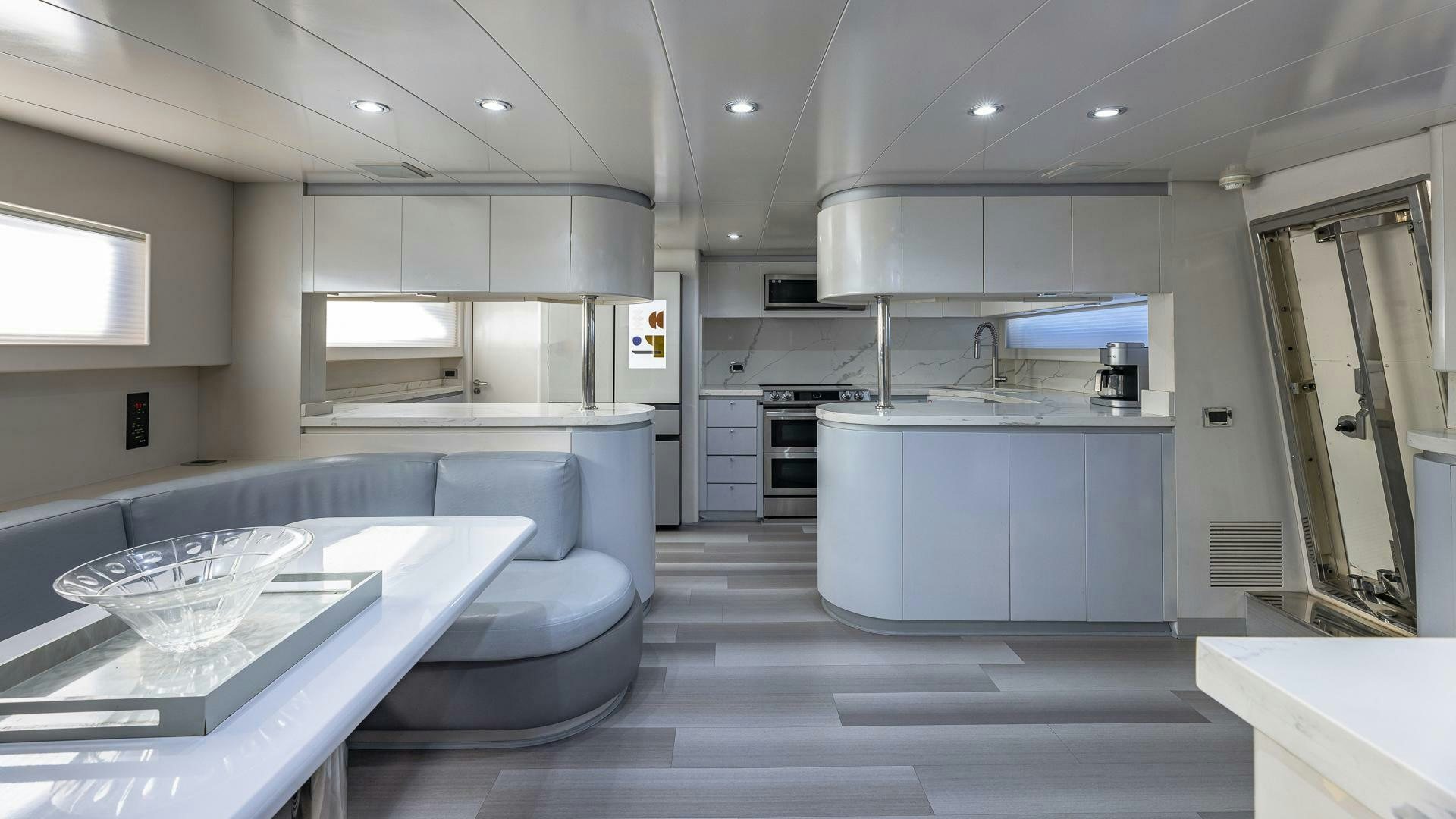 a large kitchen with a large table aboard 100 AZIMUT JUMBO Yacht for Sale