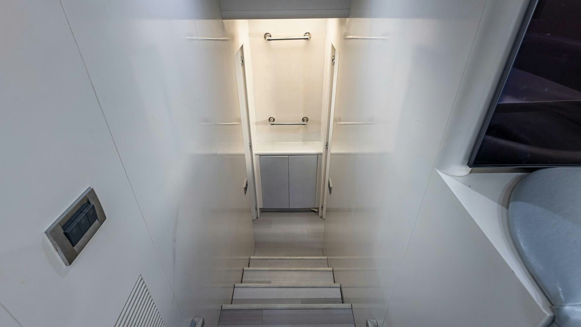 a small white room with a small television and a white door aboard 100 AZIMUT JUMBO Yacht for Sale