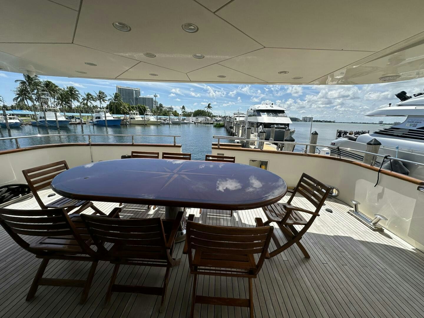 a table and chairs on a deck overlooking a body of water aboard 100 AZIMUT JUMBO Yacht for Sale