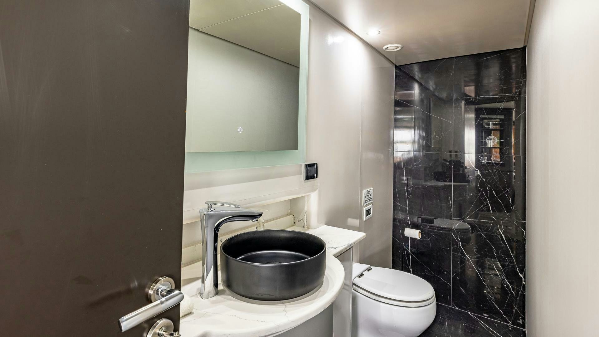 a bathroom with a sink and toilet aboard 100 AZIMUT JUMBO Yacht for Sale