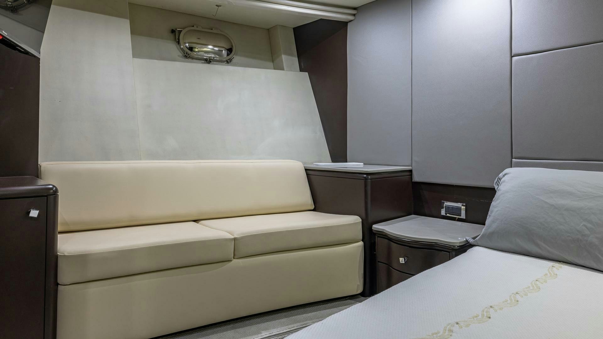 a room with a bed and a desk aboard 100 AZIMUT JUMBO Yacht for Sale