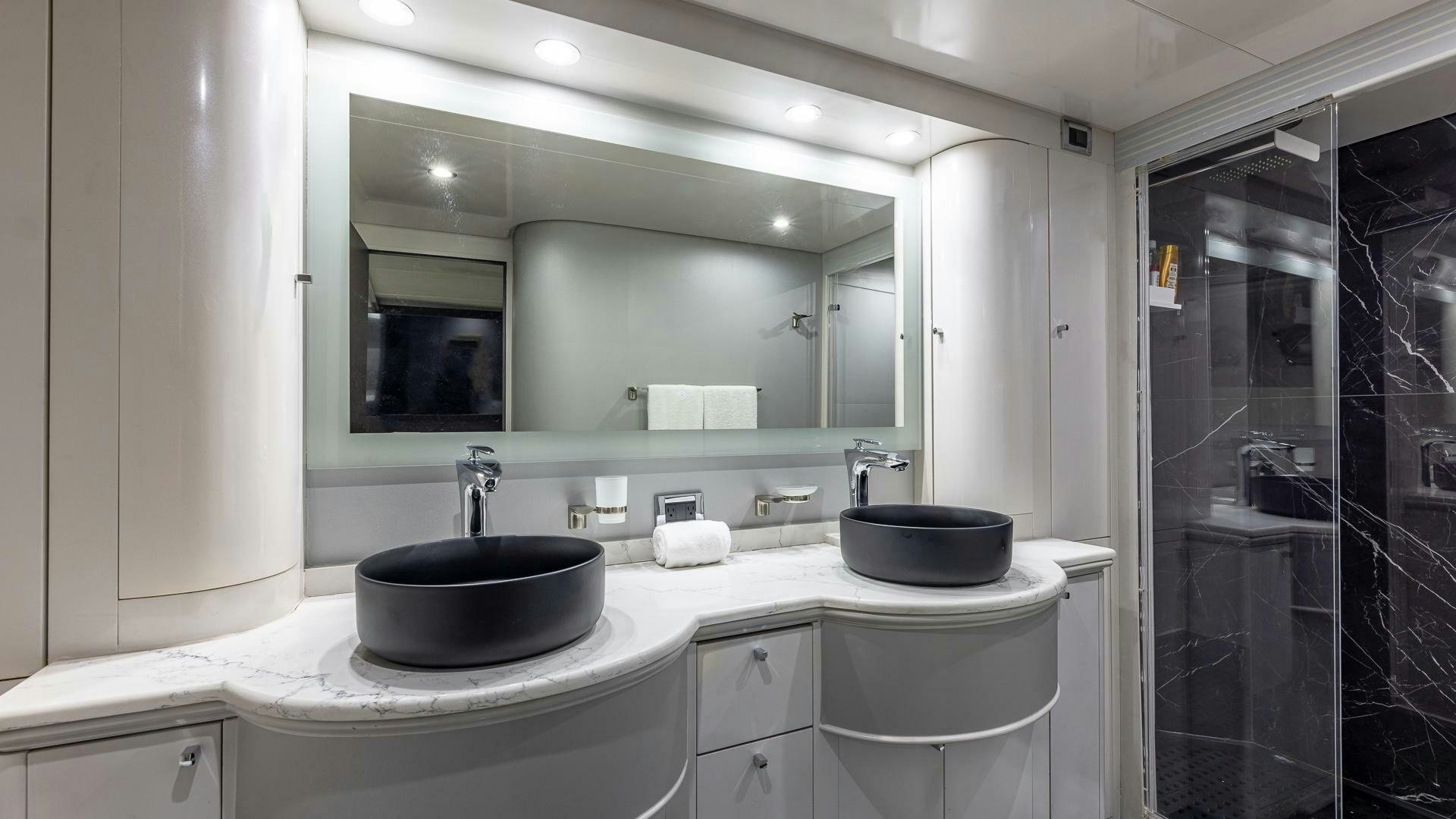a bathroom with a sink and a mirror aboard 100 AZIMUT JUMBO Yacht for Sale