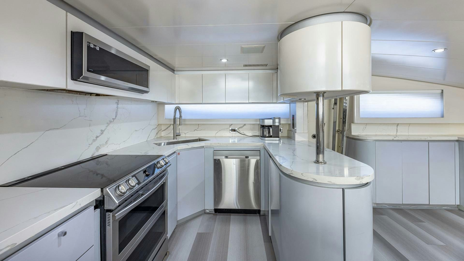 a kitchen with a stainless steel sink aboard 100 AZIMUT JUMBO Yacht for Sale