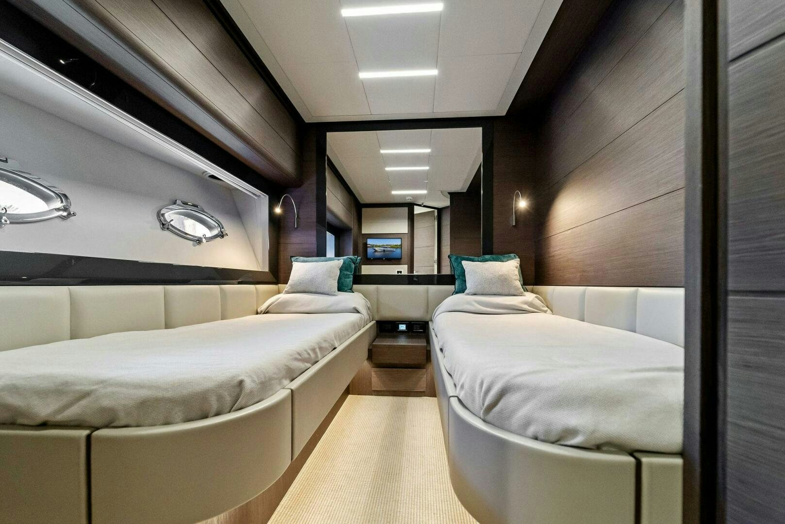 a room with beds and a tv aboard G Yacht for Sale