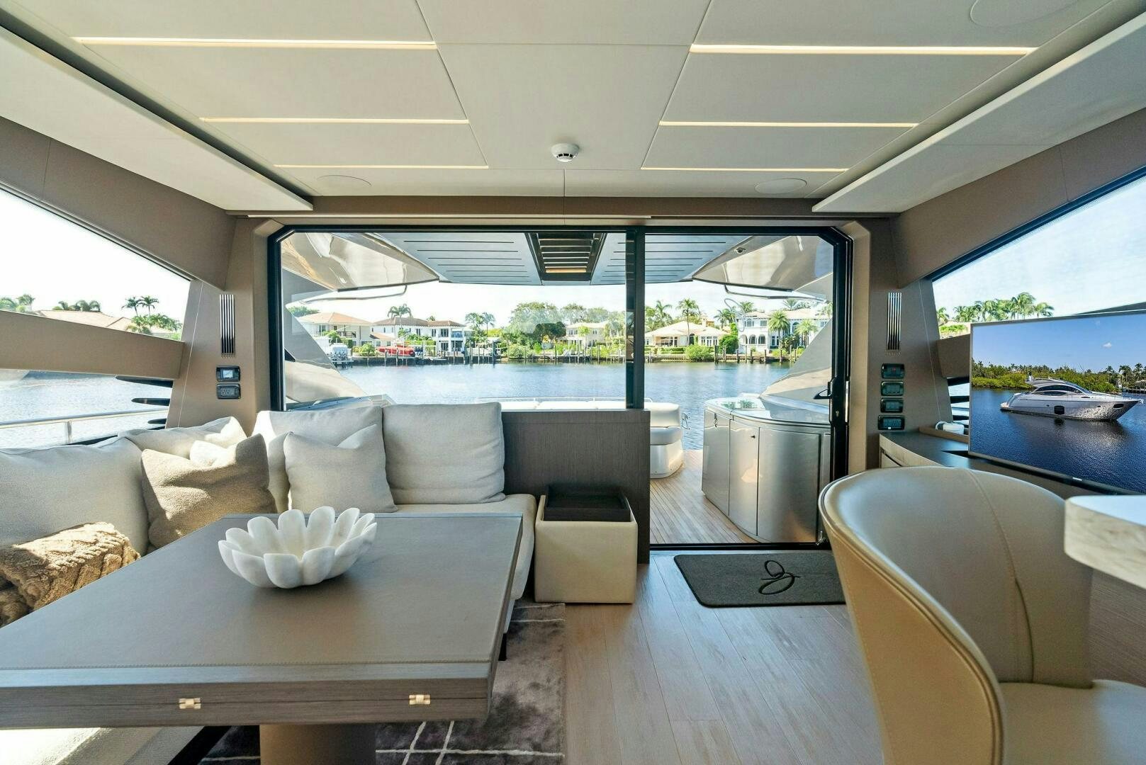 a living room with a large window aboard G Yacht for Sale