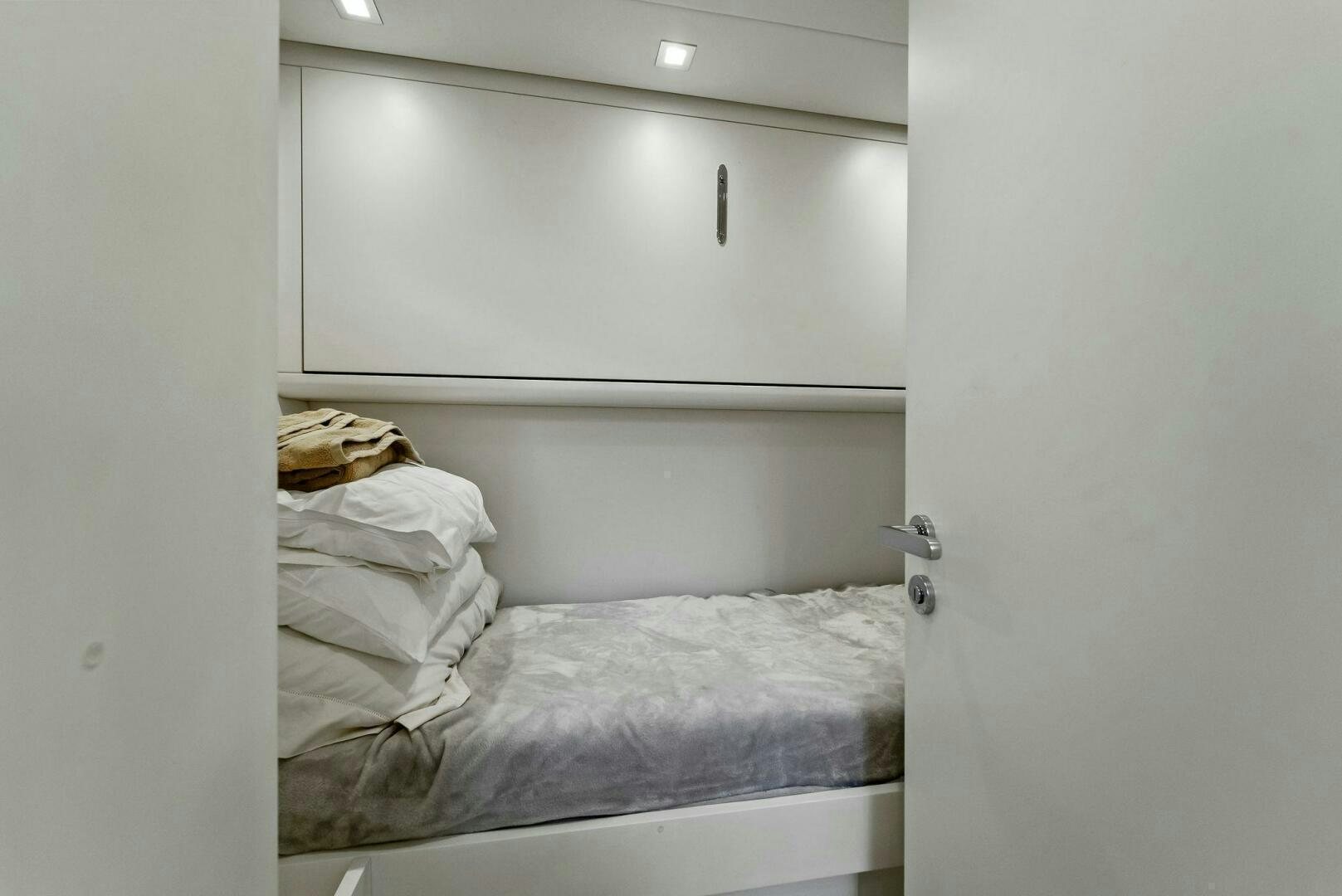 a room with white bedding aboard G Yacht for Sale