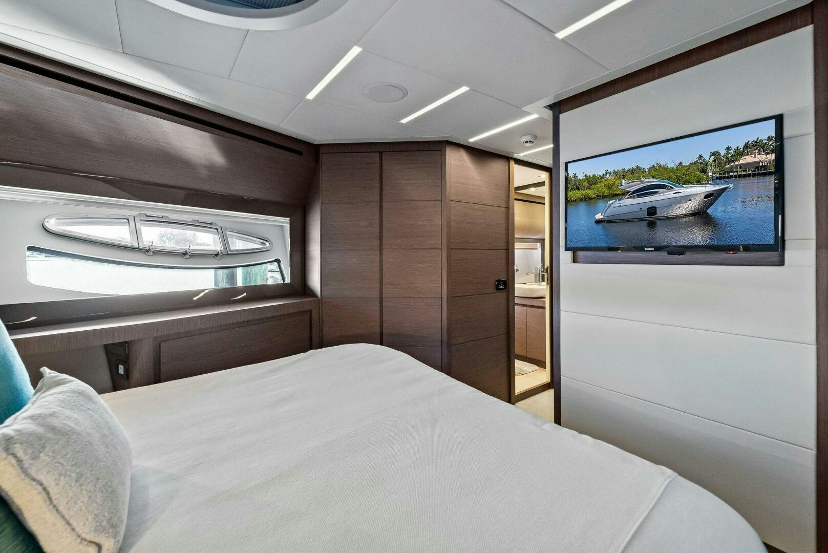a room with a bed and a television aboard G Yacht for Sale