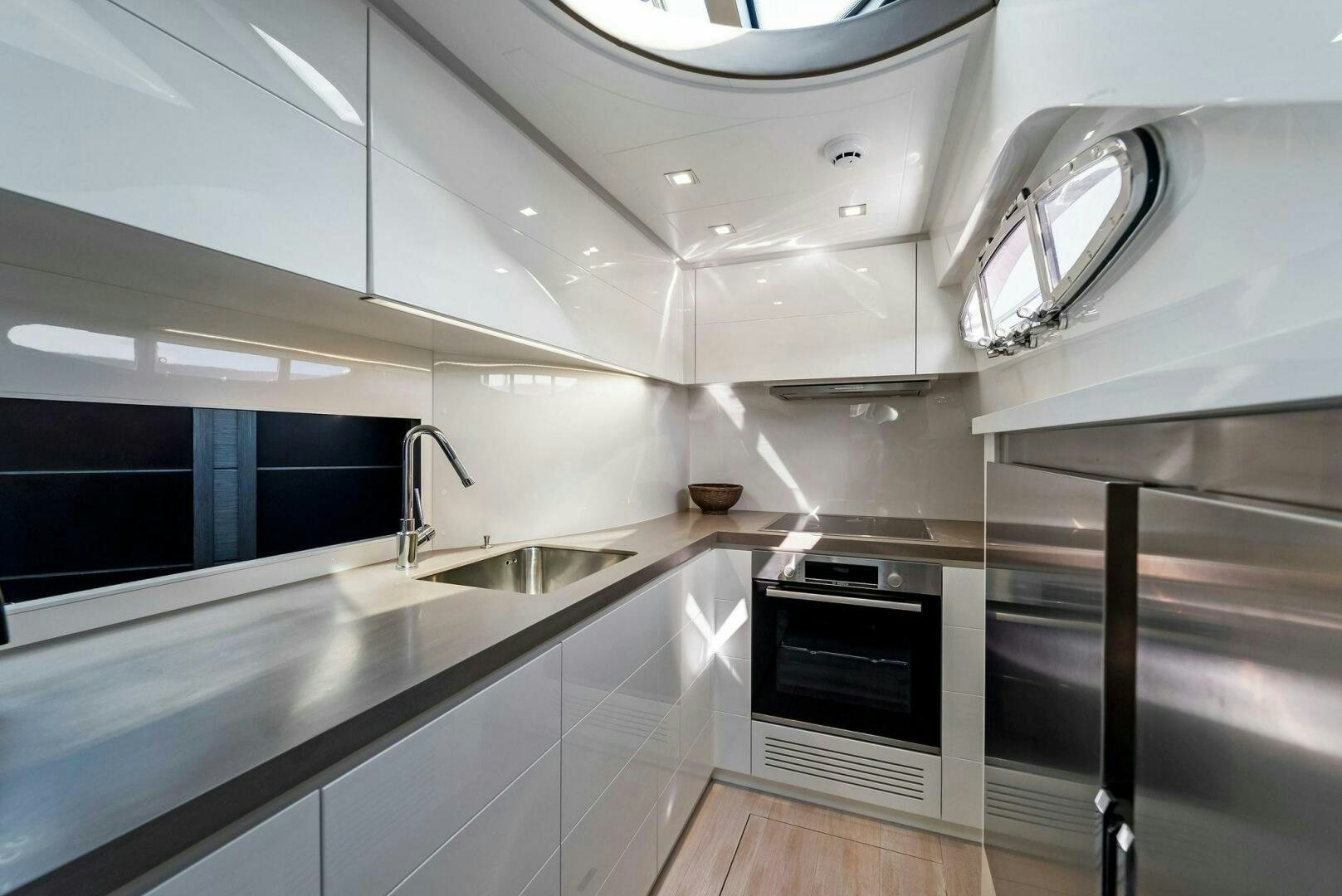 a kitchen with stainless steel appliances aboard G Yacht for Sale