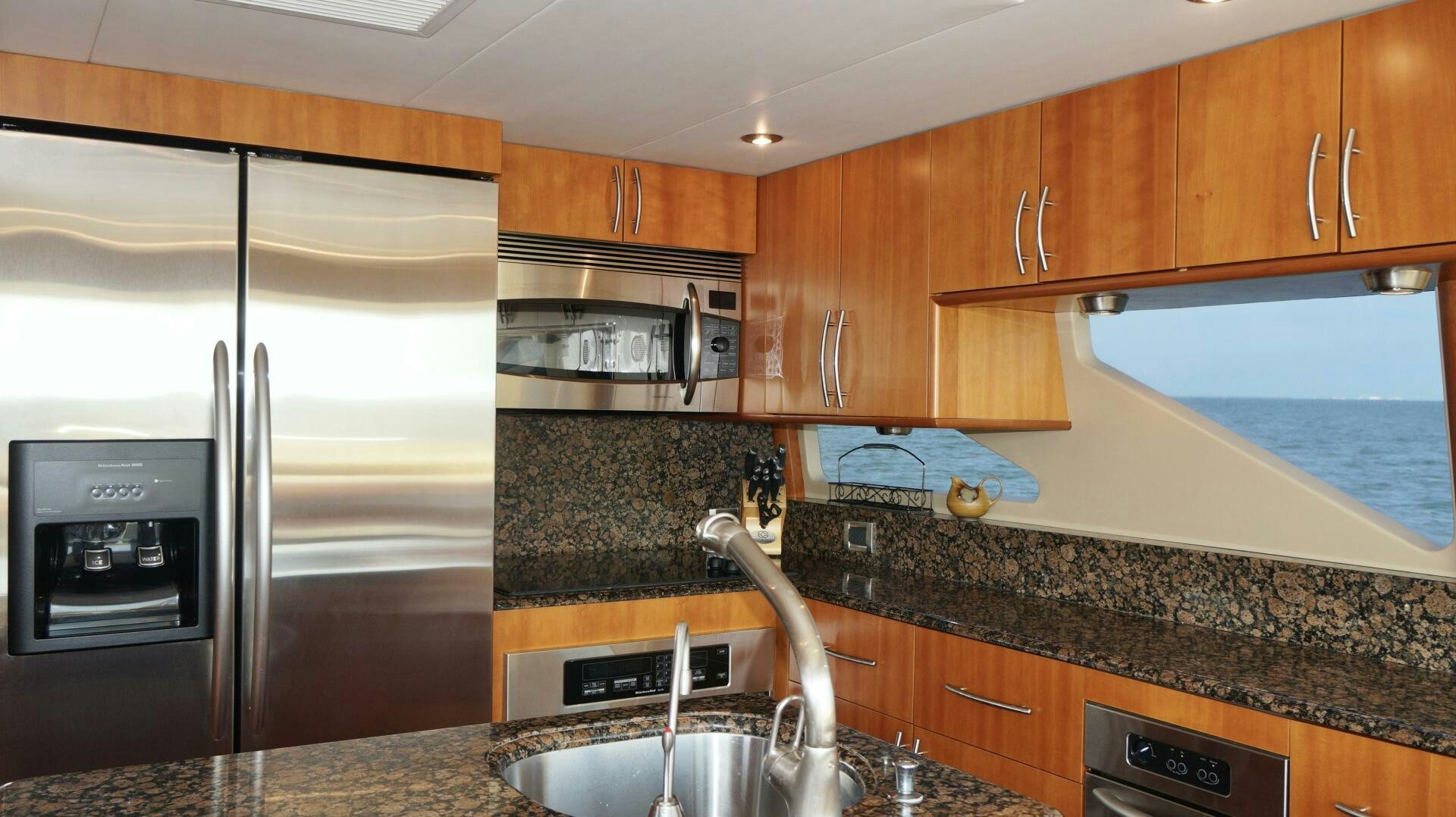 a kitchen with a stainless steel refrigerator aboard KATHLEEN Yacht for Sale